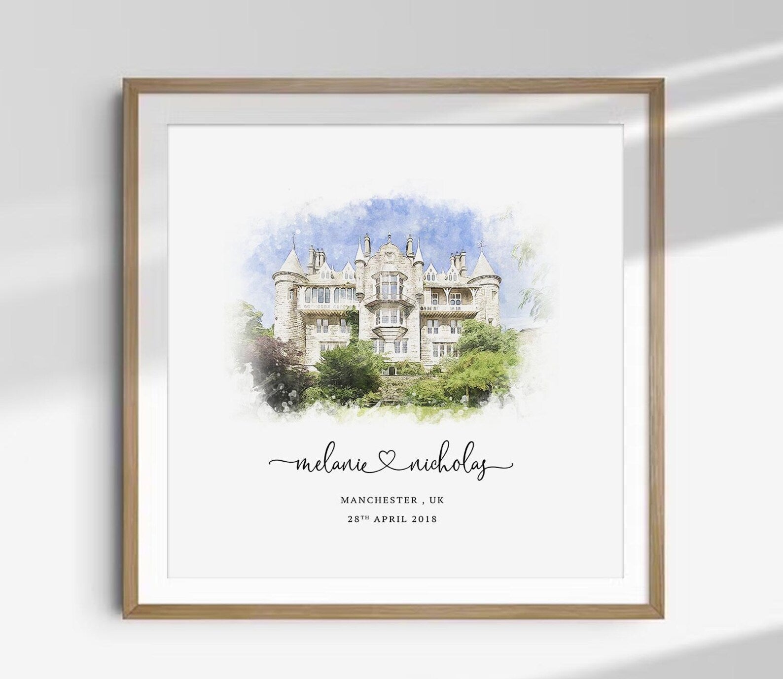 Custom watercolor wedding venue illustration featuring a historic building with personalized names, location, and wedding date in a wooden frame